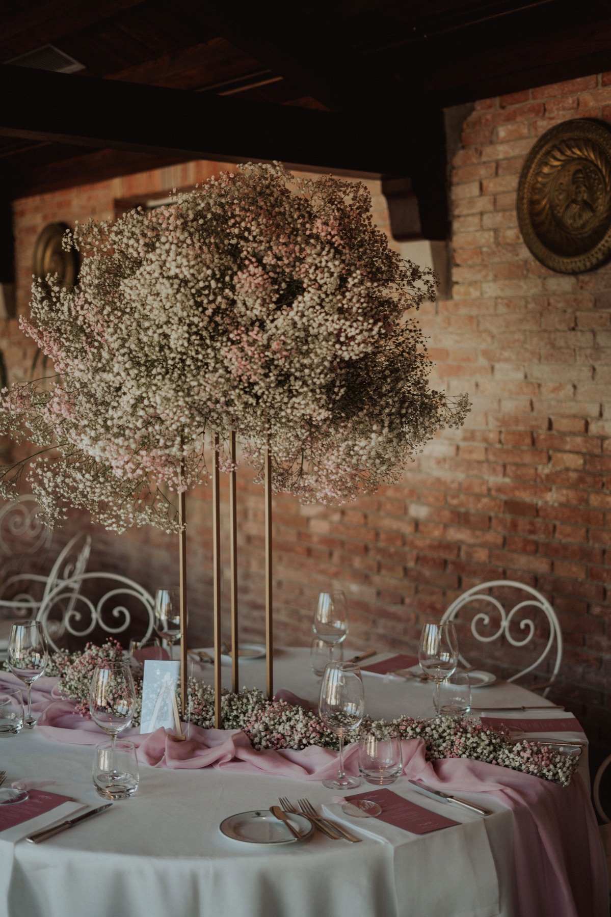 Tavolo di matrimonio allestito con tovaglia rosa e candele