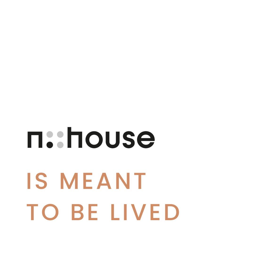 The n::house logo with the claim is meant to be lived in orange